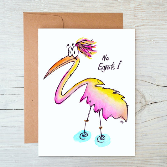 front side of hand-drawn, hand-painted card of a colorful, whimsical watercolor Egret with brown kraft envelope behind it on a background of white-washed wood