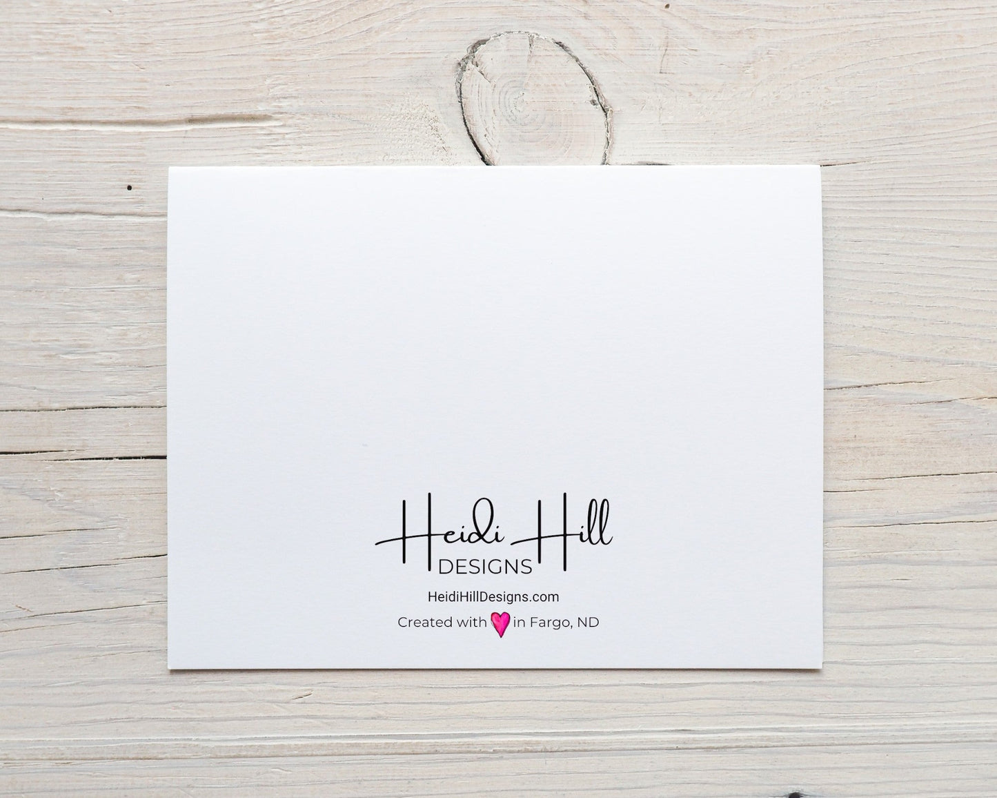 back of card with HeidiHillDesigns.com logo and the phrase "created with (hand-drawn pink heart) love in Fargo, ND"